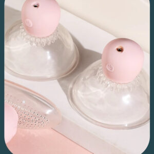 Pastel pink suction cups and massage tool for innovative skincare and wellness solutions.