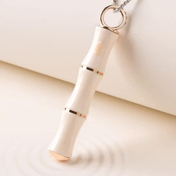 Elegant beauty tool with white and gold design, perfect for skincare and self-care routines.