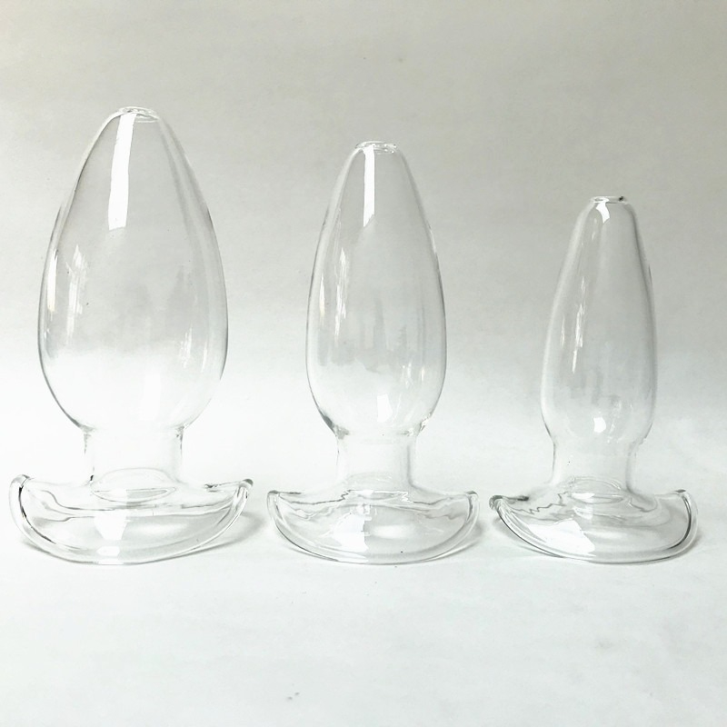 Elegant glass teardrop objects in graduated sizes, perfect for decorative or intimate settings.