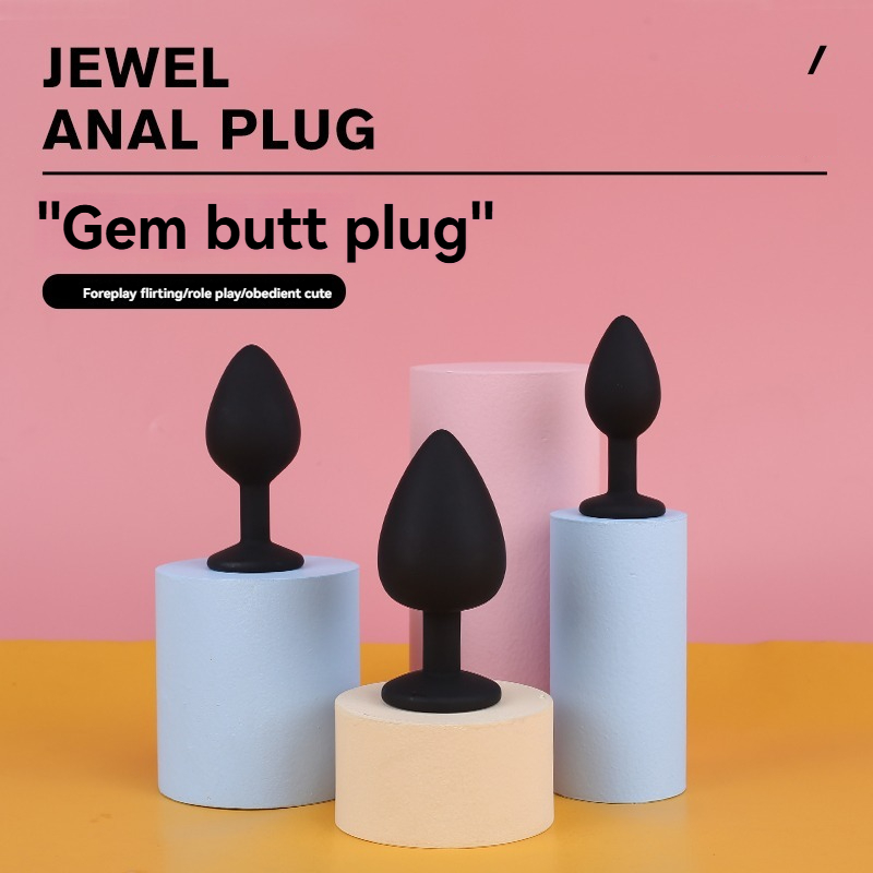 Colorful jewel anal plugs on pastel pedestals for playful and intimate experiences.