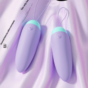 Lavender personal devices with mint accents for discreet, intimate pleasure on luxurious fabric.