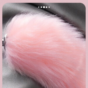 Fluffy pink fox tail, soft and playful, perfect for sensual and whimsical experiences.