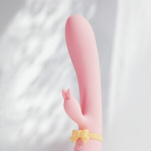 Charming pink rabbit toy with buttons for playful intimacy and modern design.