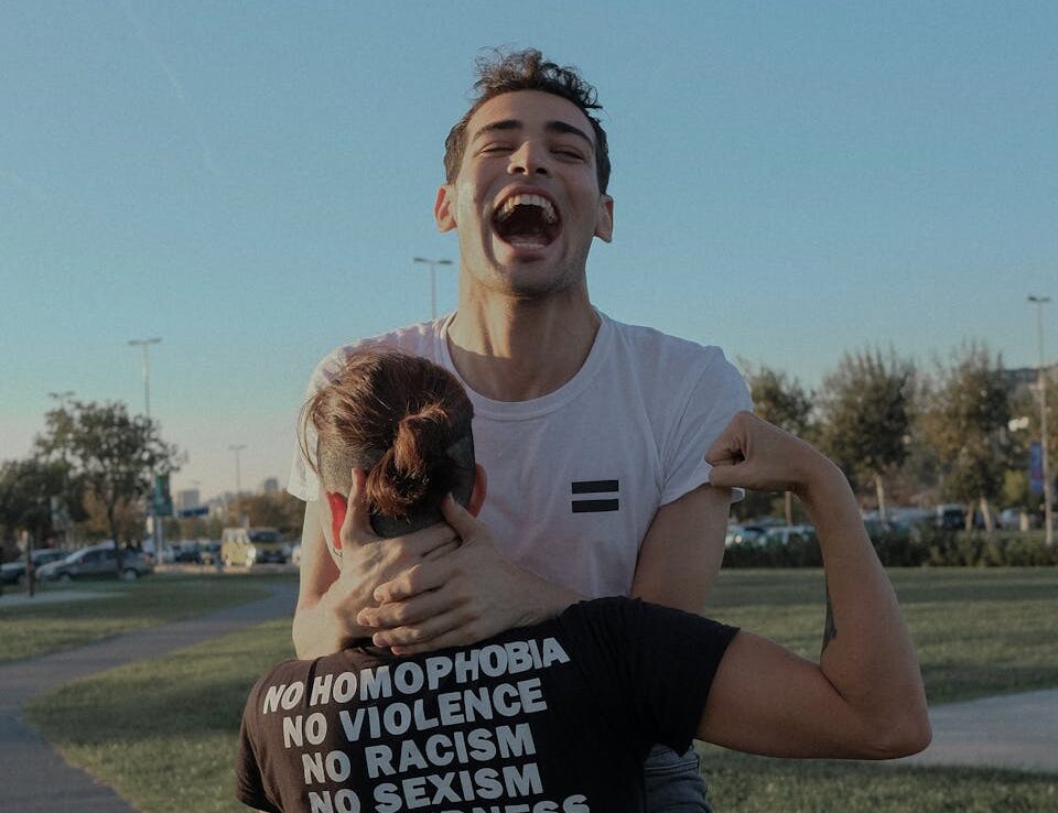 A joyful couple embraces equality and joy in an outdoor setting in İstanbul, Turkey.