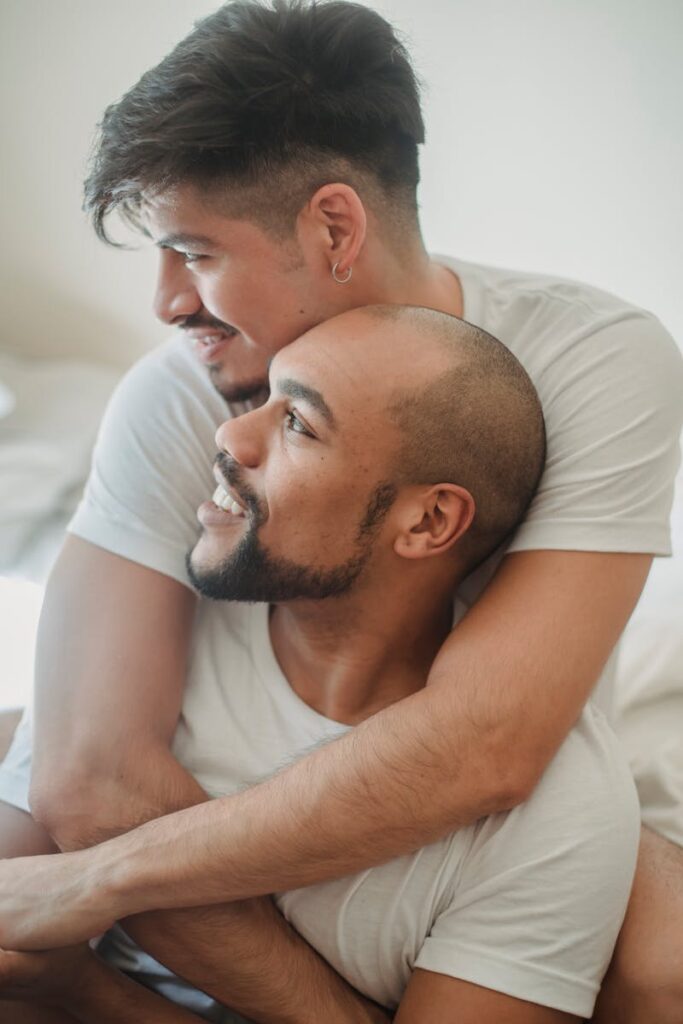 Happy couple embracing with affection, showcasing LGBTQ+ love and intimacy.