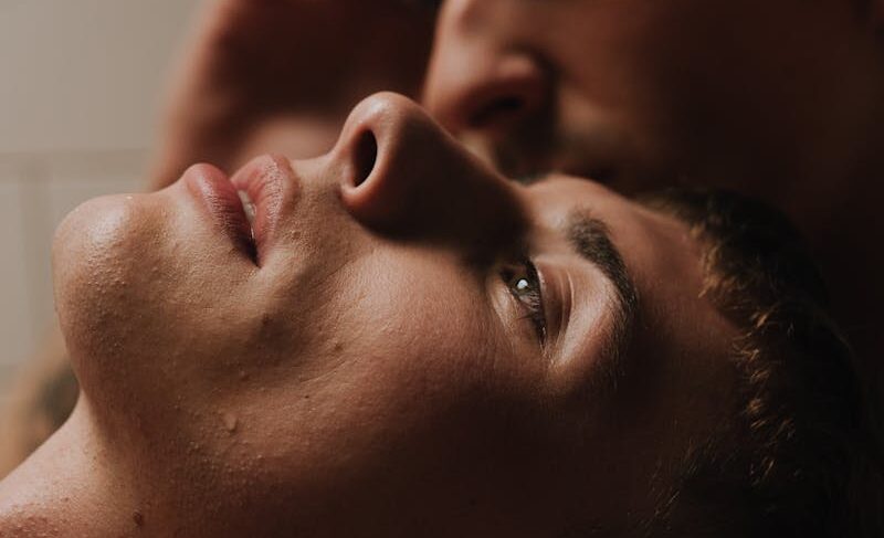 Close-up of a thoughtful, affectionate couple embracing indoors.