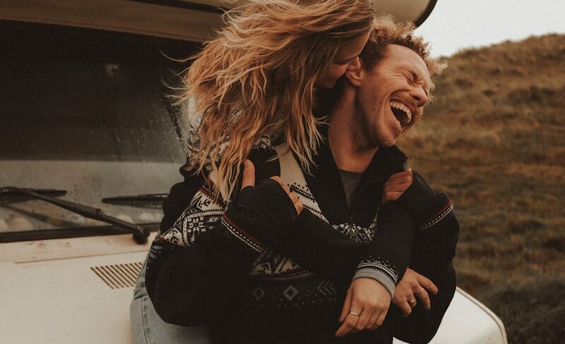 a man and a woman standing in front of a truck