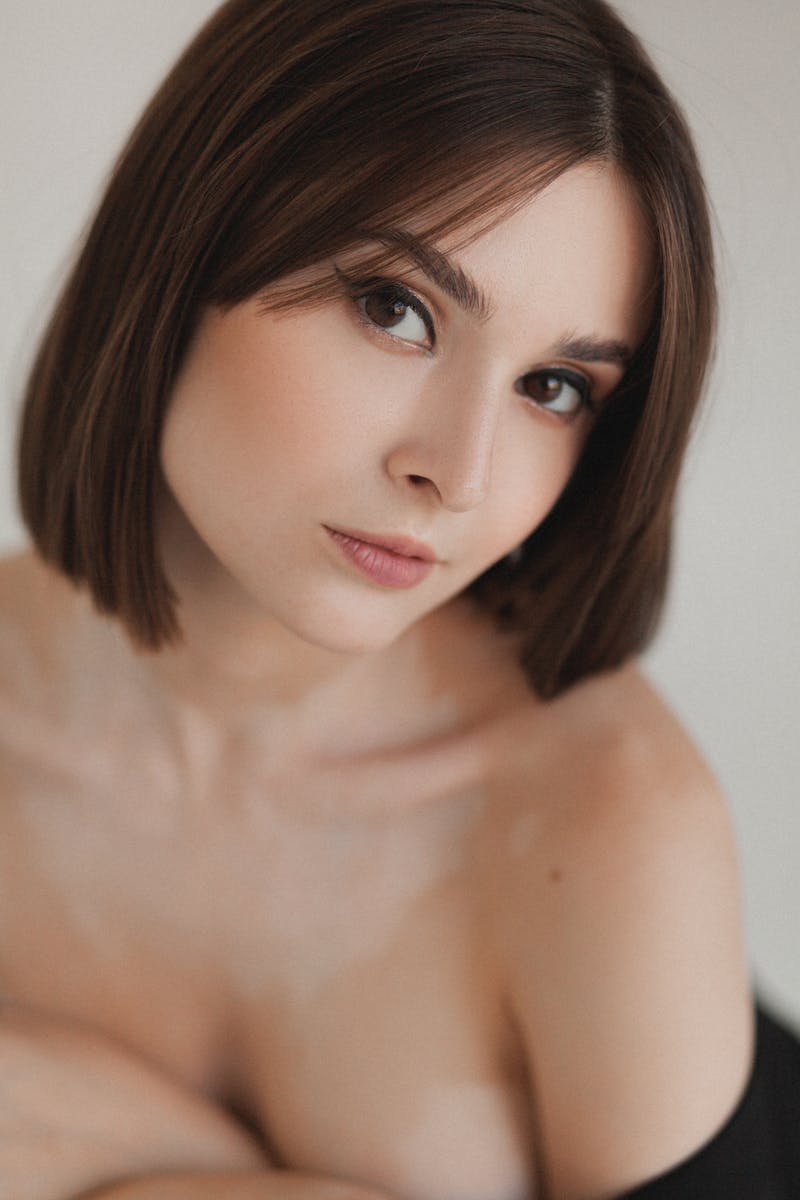 Beautiful portrait of a woman with natural makeup and soft lighting, showcasing elegance and poise.