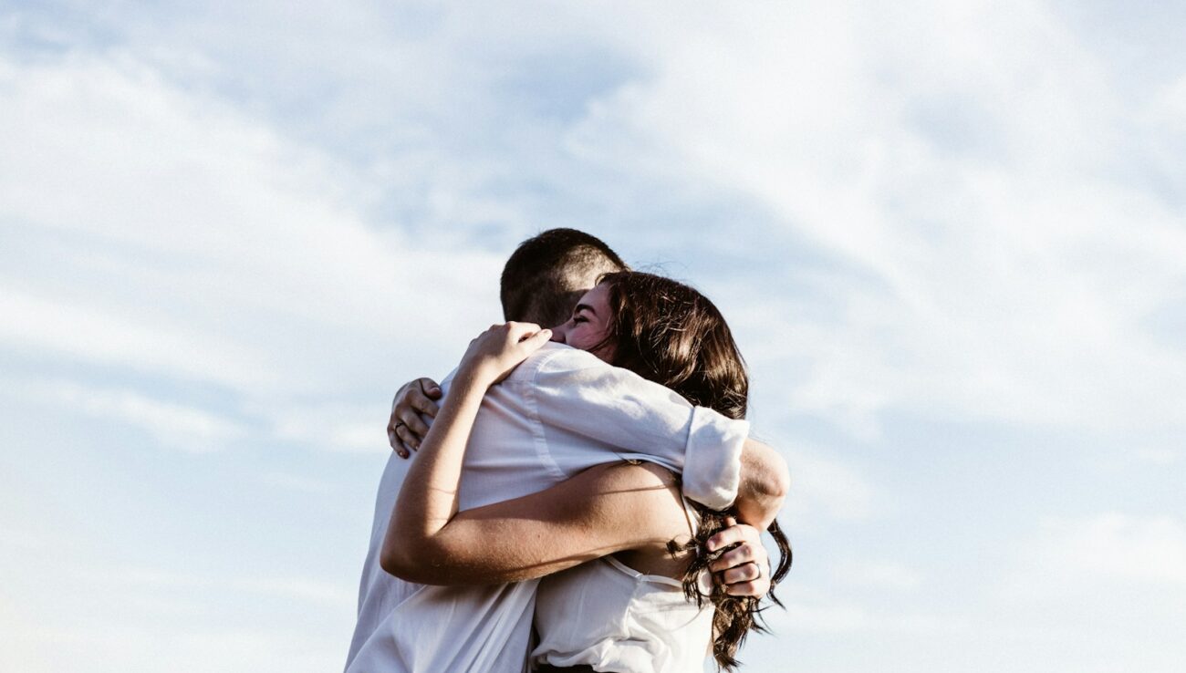 man and woman hugging each other photography