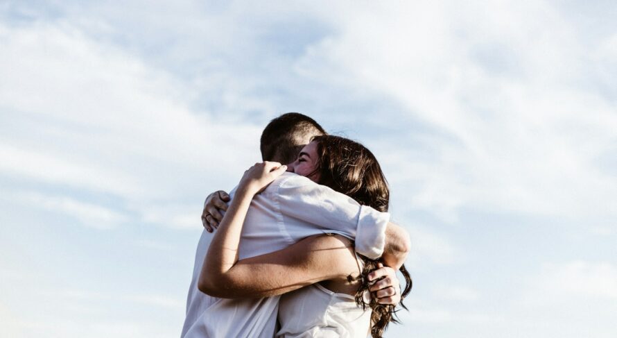 man and woman hugging each other photography