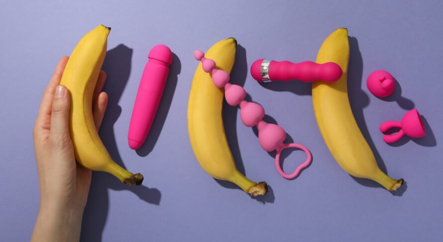 A collection of sex toys on a purple background.