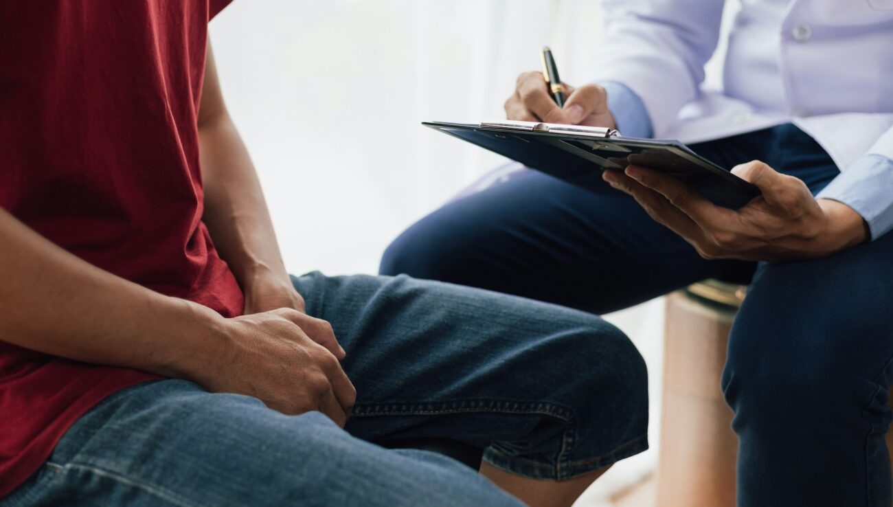 A man suffering from sexual dysfunction visits a doctor for treatment. Male health problem concept.