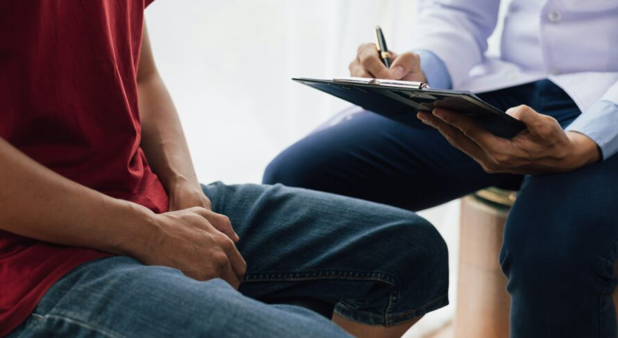 A man suffering from sexual dysfunction visits a doctor for treatment. Male health problem concept.