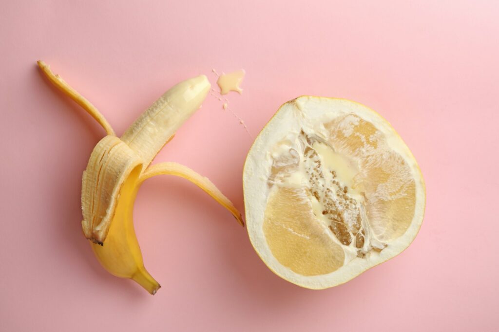 Banana and pomelo fruit with condensed milk on pink background