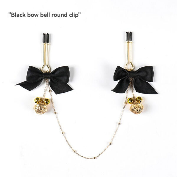 Stylish black bow hair clip with playful golden bells perfect for accessorizing any look.