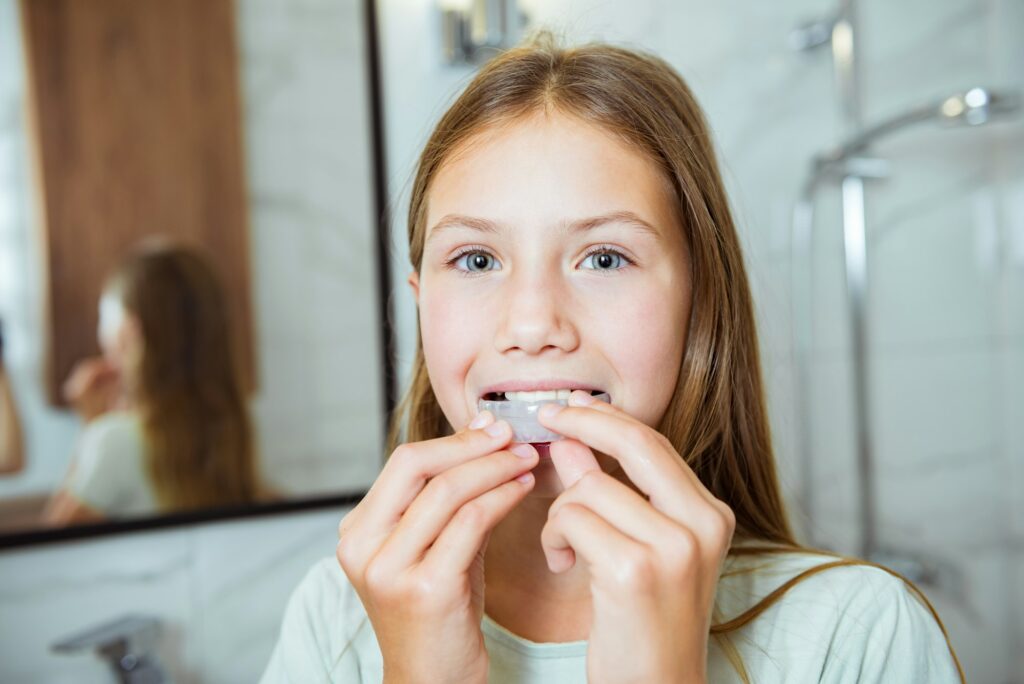 Dental simulator for teeth alignment. The child inserts mouth guards on his teeth