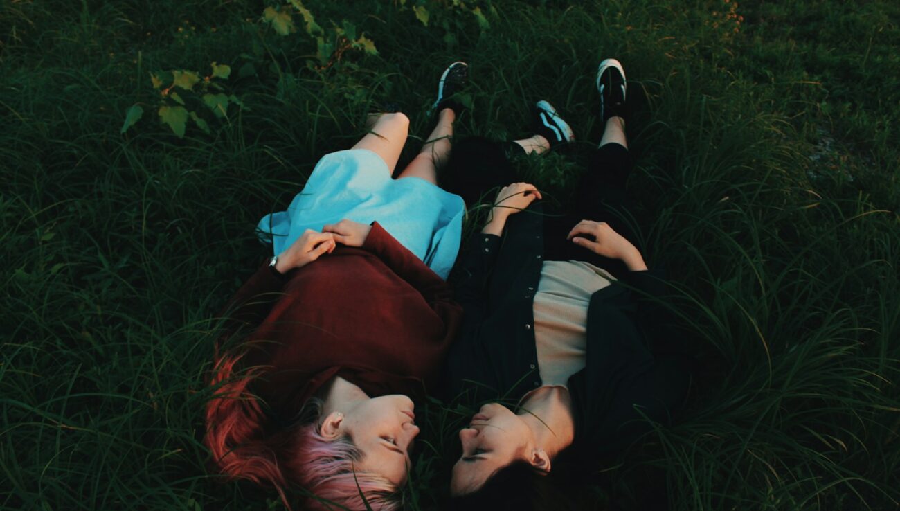 two women lying on grasses