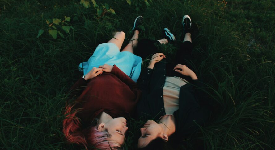 two women lying on grasses