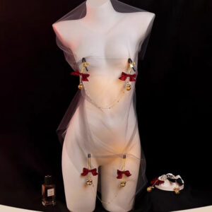 Stylish mannequin draped in tulle, adorned with red bows and golden bells for a whimsical allure.