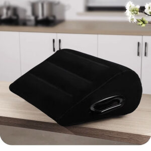 Sleek black wedge pillow for ergonomic support in a modern kitchen setting.