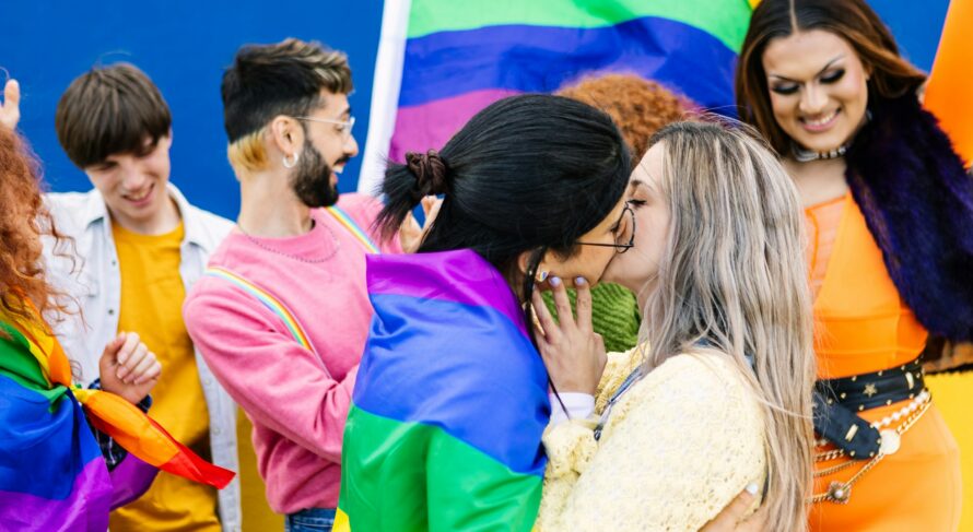 LGBTQ community people with rainbow flag celebrating gay pride festival day.