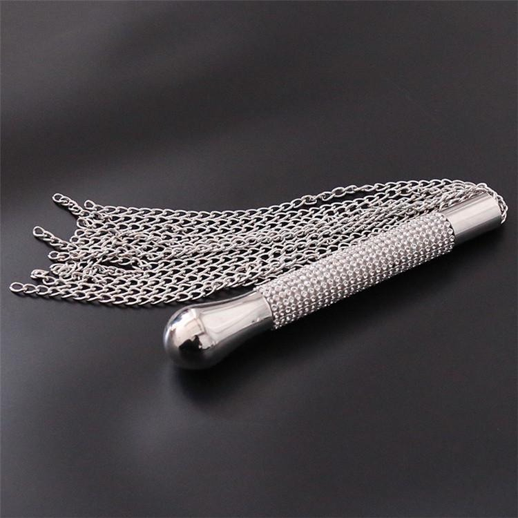 Elegant metallic decorative tool with crystal accents and cascading chains for stylish aesthetic use.