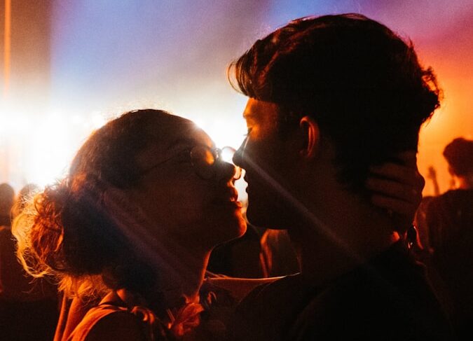 man and woman kissing during night time