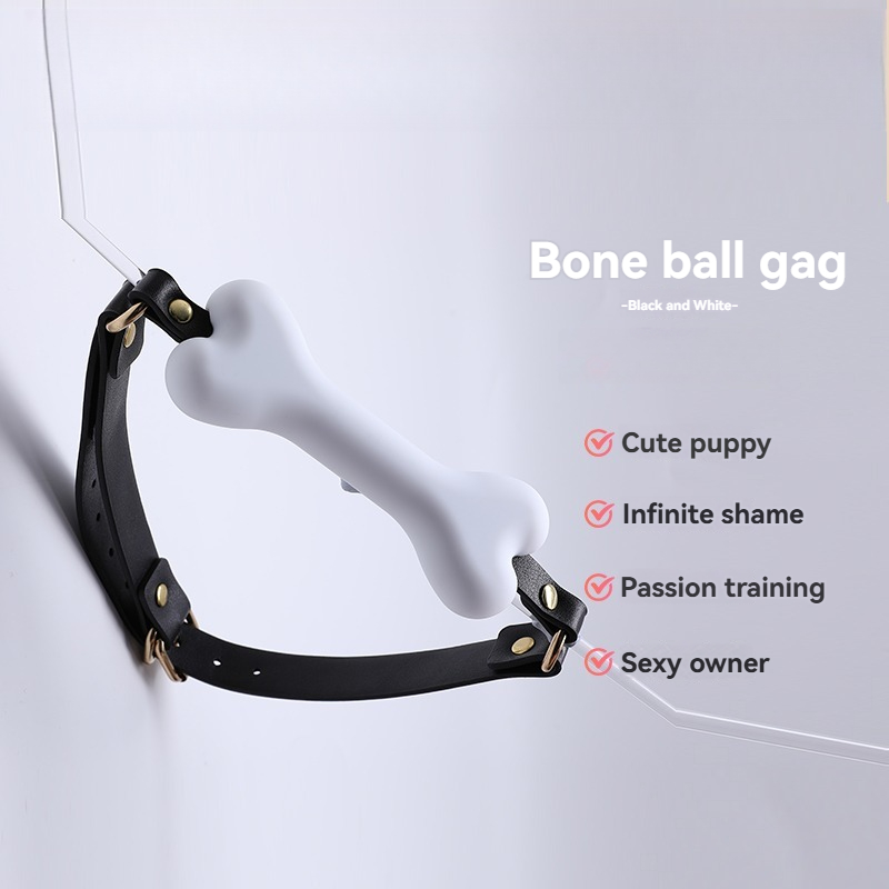 Juguetona mordaza de bola de hueso blanco con correas negras para divertidos accesorios de juego para adultos.
