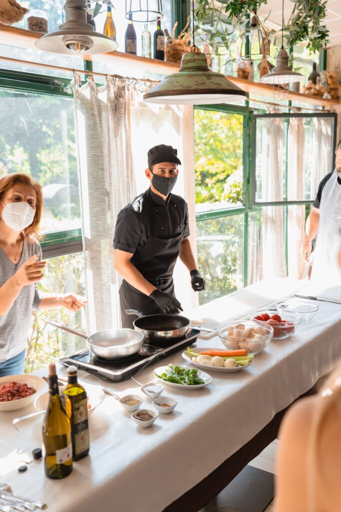 a group of people sitting at a table with a plate of food