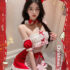 Festive woman in playful Santa costume spreads Christmas joy in vibrant red and white attire.