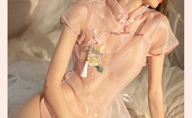 Elegant Woman in Pastel Pink with Floral Embroidery Elegant woman in pastel pink outfit, showcasing beauty and sophistication in a serene setting.