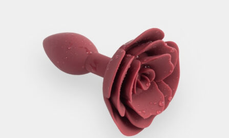 Deep red rose-shaped silicone pleasure device, combining beauty and functionality for intimate experiences.