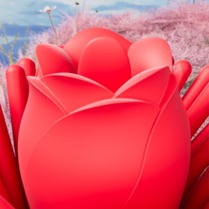 Vibrant red rose with smooth tendrils set against whimsical pastel pink grass and serene water.