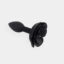 Elegant black rose-shaped accessory with water droplets, perfect for sensual experiences.